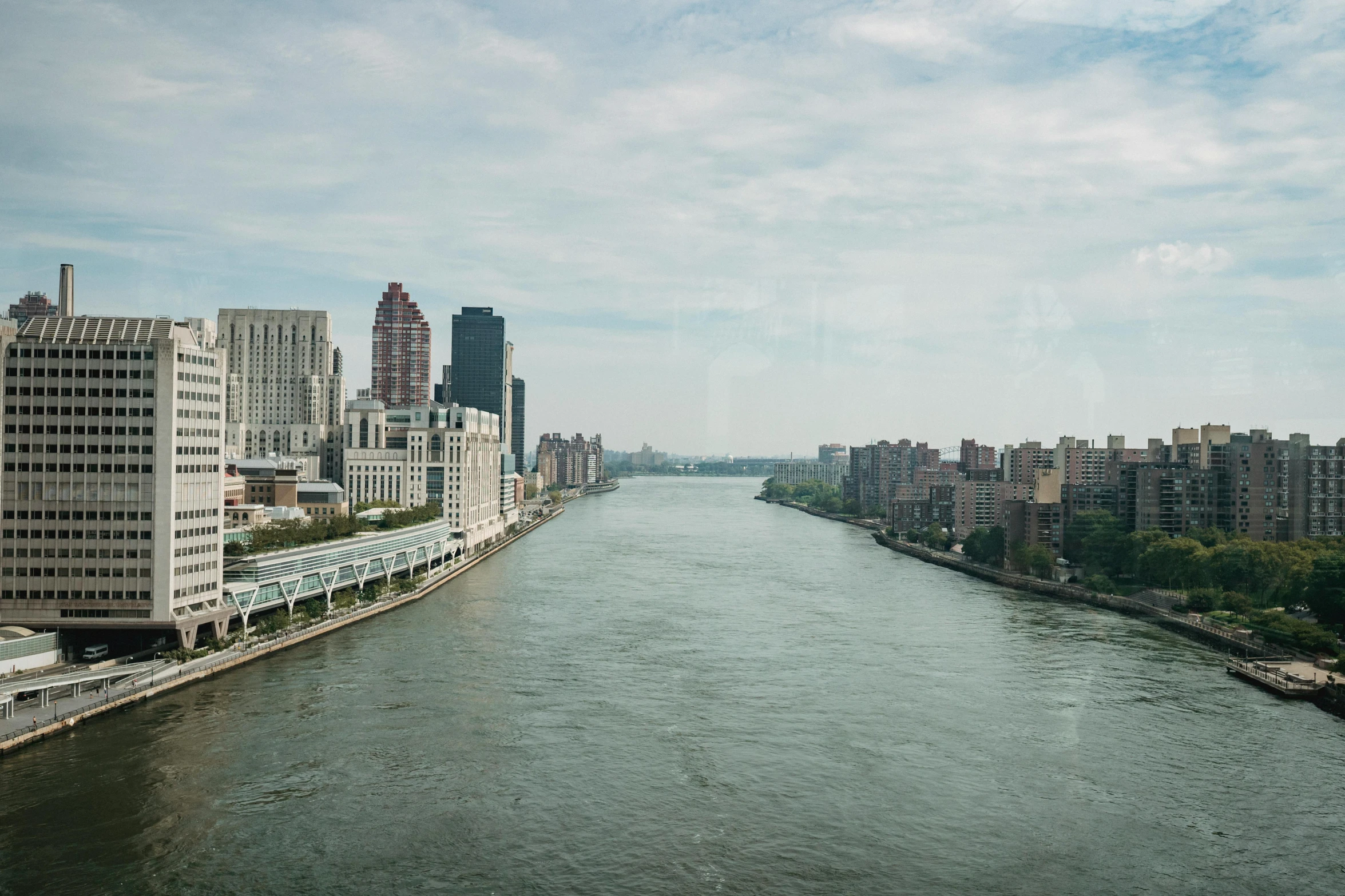 a river running through a city next to tall buildings, a picture, harlem, high-resolution photo, fan favorite, window view