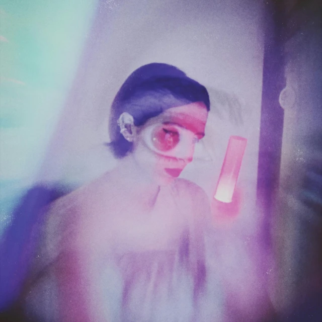 a close up of a person holding a cell phone, a polaroid photo, by Sam Havadtoy, conceptual art, glowing lens flare wraith girl, melanie martinez, technicolor film expired film, futuristic ballroom. big eyes