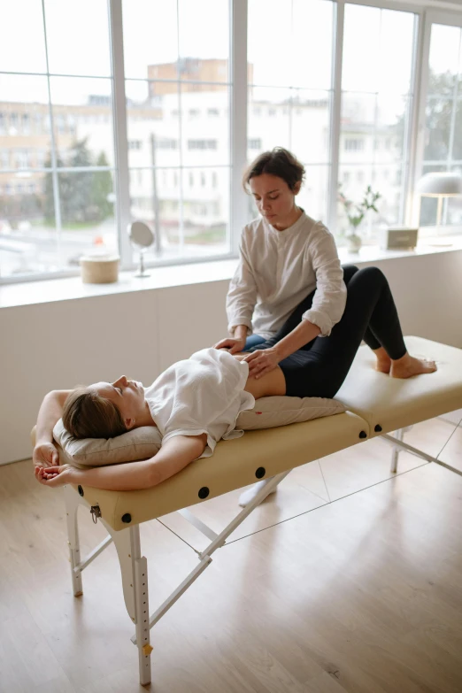 a woman getting a massage in a room, on a table, ouchh and and innate studio, angled, ekaterina