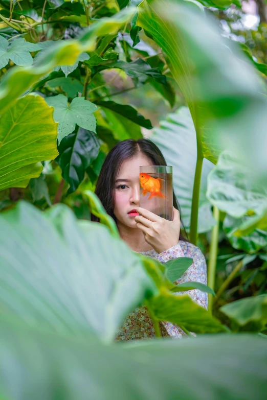 a woman holding a flower in front of her face, a picture, inspired by Ren Hang, unsplash, visual art, lush greenery, girl under lantern, 8k 50mm iso 10, beautiful asian girl