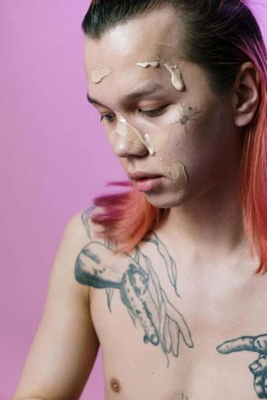 a man with tattoos on his chest using a cell phone, by Jessie Alexandra Dick, trending on pexels, hyperrealism, pink face, cream dripping on face, nonbinary model, asian male