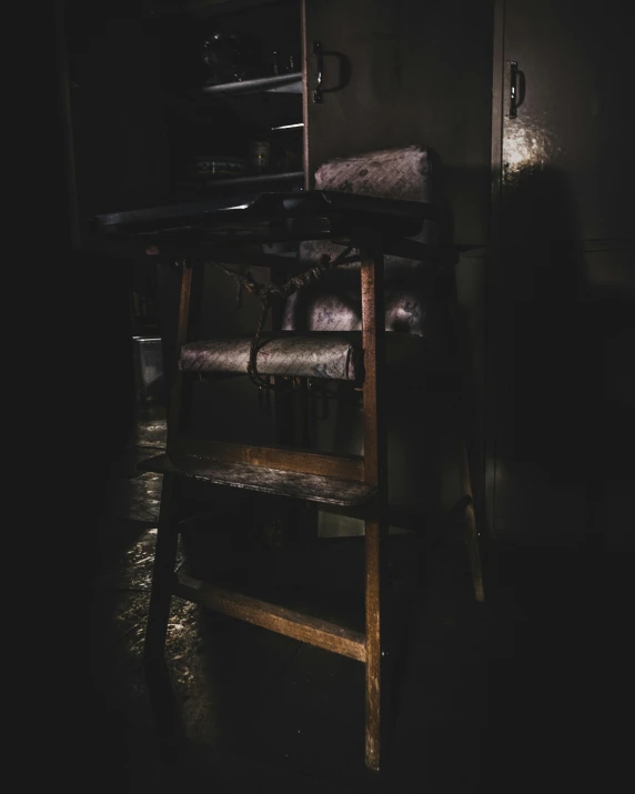 a chair sitting in the middle of a dark room, an album cover, unsplash, ladder, wet collodion, dark kitchen, scp-173