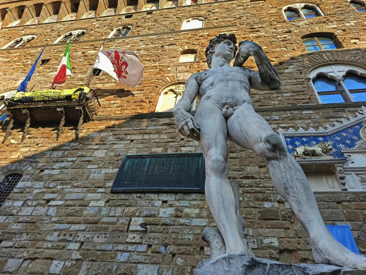 a statue of a man standing in front of a building, a statue, inspired by Michelangelo Buonarotti, pexels contest winner, bargello, square, 💋 💄 👠 👗, thumbnail