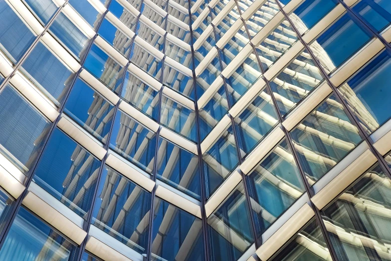 a very tall building with a lot of windows, inspired by Zaha Hadid, unsplash, square lines, blue reflections, intricate image, steel window mullions