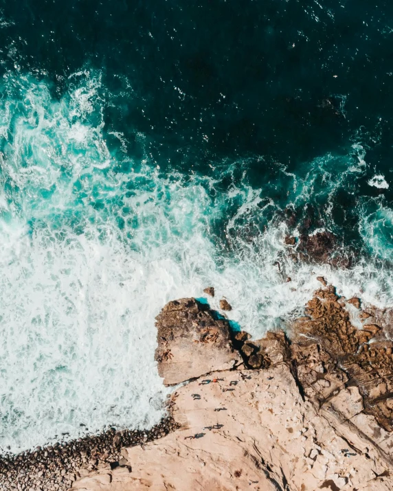 a person standing on top of a cliff next to the ocean, pexels contest winner, foamy waves, flatlay, manly, slide show