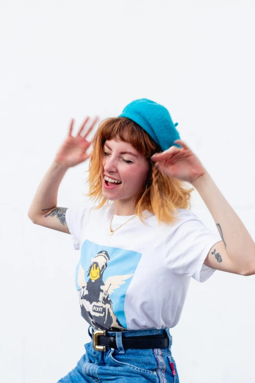 a woman in a white shirt and blue hat, an album cover, inspired by Hannah Frank, unsplash, laughing, wearing a t-shirt, triumphant pose, portrait of max caulfield