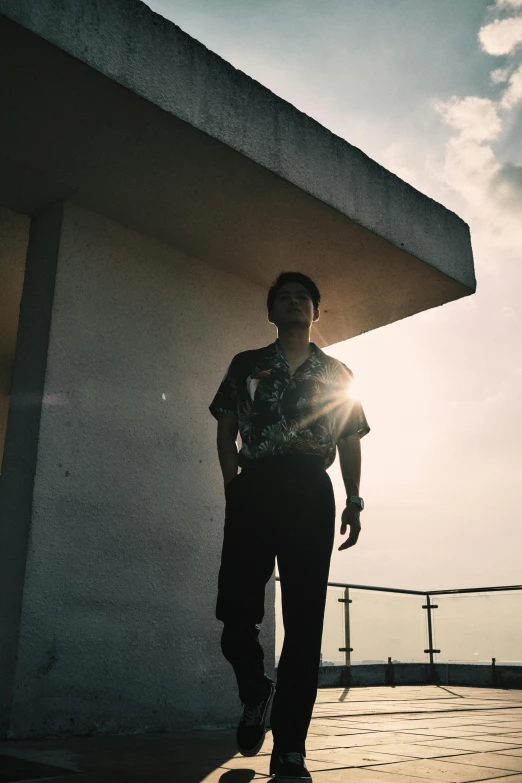 a man riding a skateboard down a sidewalk, an album cover, unsplash, looking off into the sunset, standing on a rooftop, asian male, grainy footage