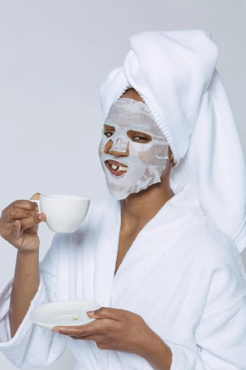 a woman in a bathrobe drinking a cup of coffee, the mask covers her entire face, even skin tone, ultra facial detail, face shown