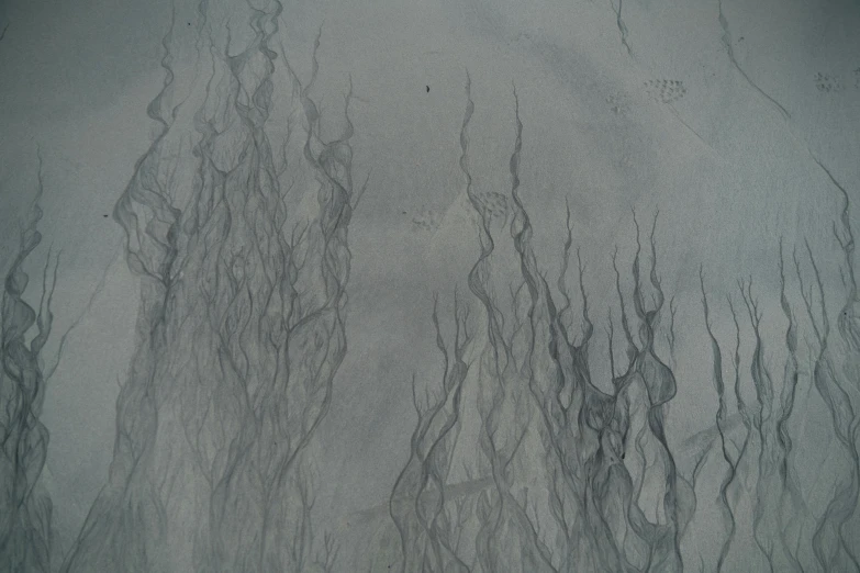 a close up of water and sand on a beach, an abstract drawing, inspired by Vija Celmins, trending on deviantart, wispy tendrils of smoke, pencil lines, microscopic view, small flames