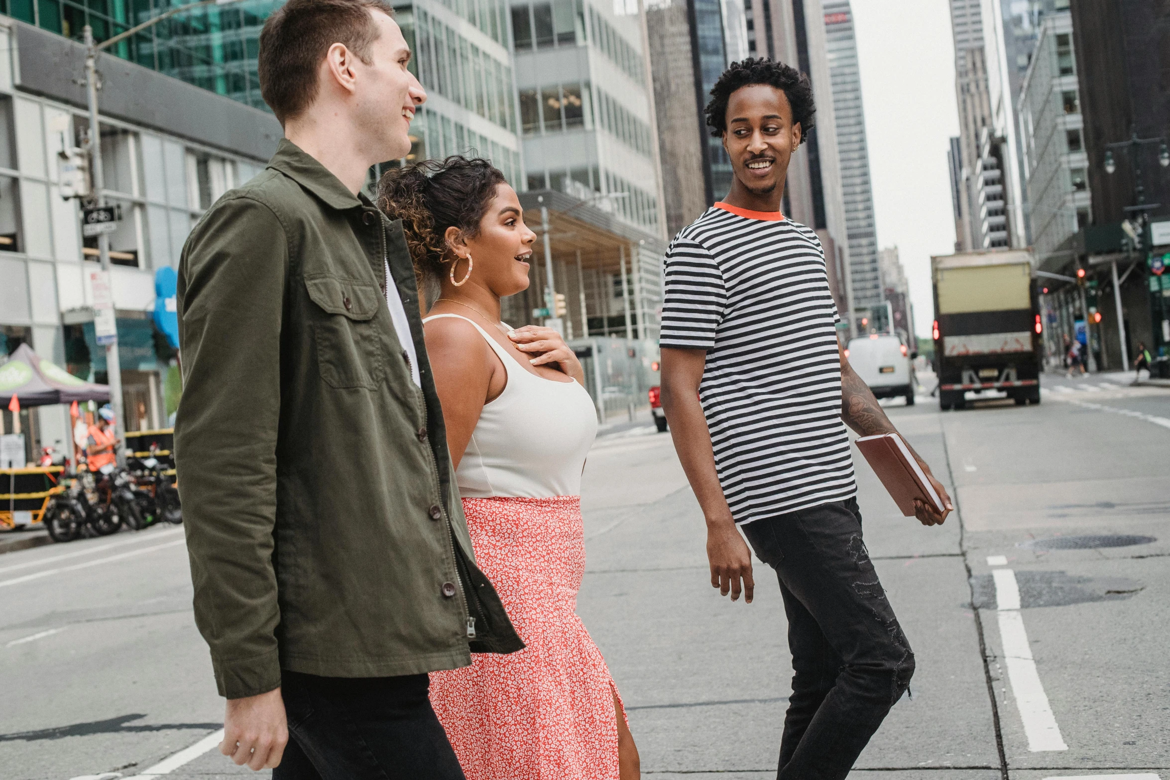 a group of people walking down a city street, wearing casual clothing, promotional image, tall shot, abcdefghijklmnopqrstuvwxyz