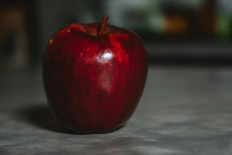 a red apple sitting on top of a counter, pexels contest winner, background image, unedited, profile image, flash photo