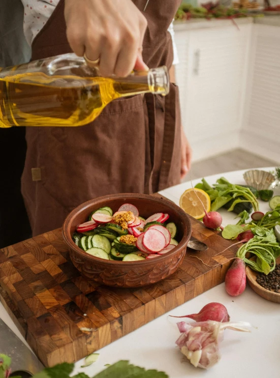 a person pouring olive into a bowl of salad, by Julia Pishtar, detailed product image, brown, cooking oil, full-body