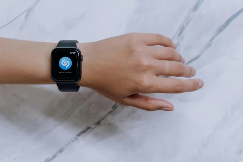 a person with an apple watch on their wrist, an album cover, pexels, background image, letter s, square, no watermark