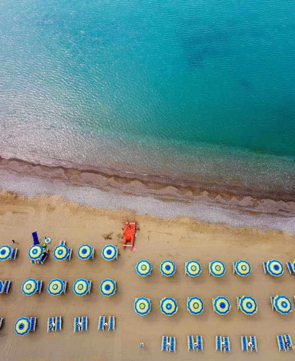 a beach filled with lots of blue and white umbrellas, an album cover, by Robbie Trevino, pexels contest winner, renaissance, turquoise and orange, wide high angle view, vouge italy, slide show