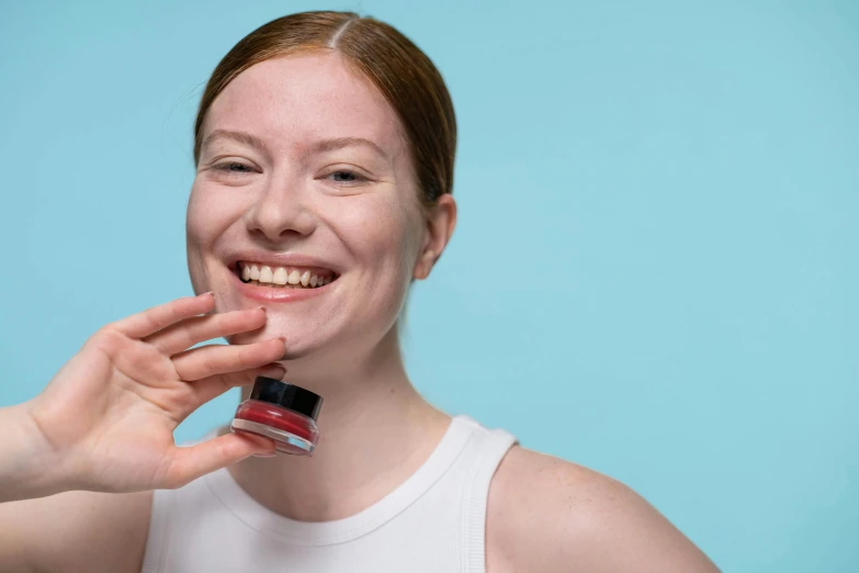 a woman brushing her teeth with a toothbrush, pexels contest winner, antipodeans, holding hot sauce, red and cyan ink, smiling fashion model face, it has a red and black paint