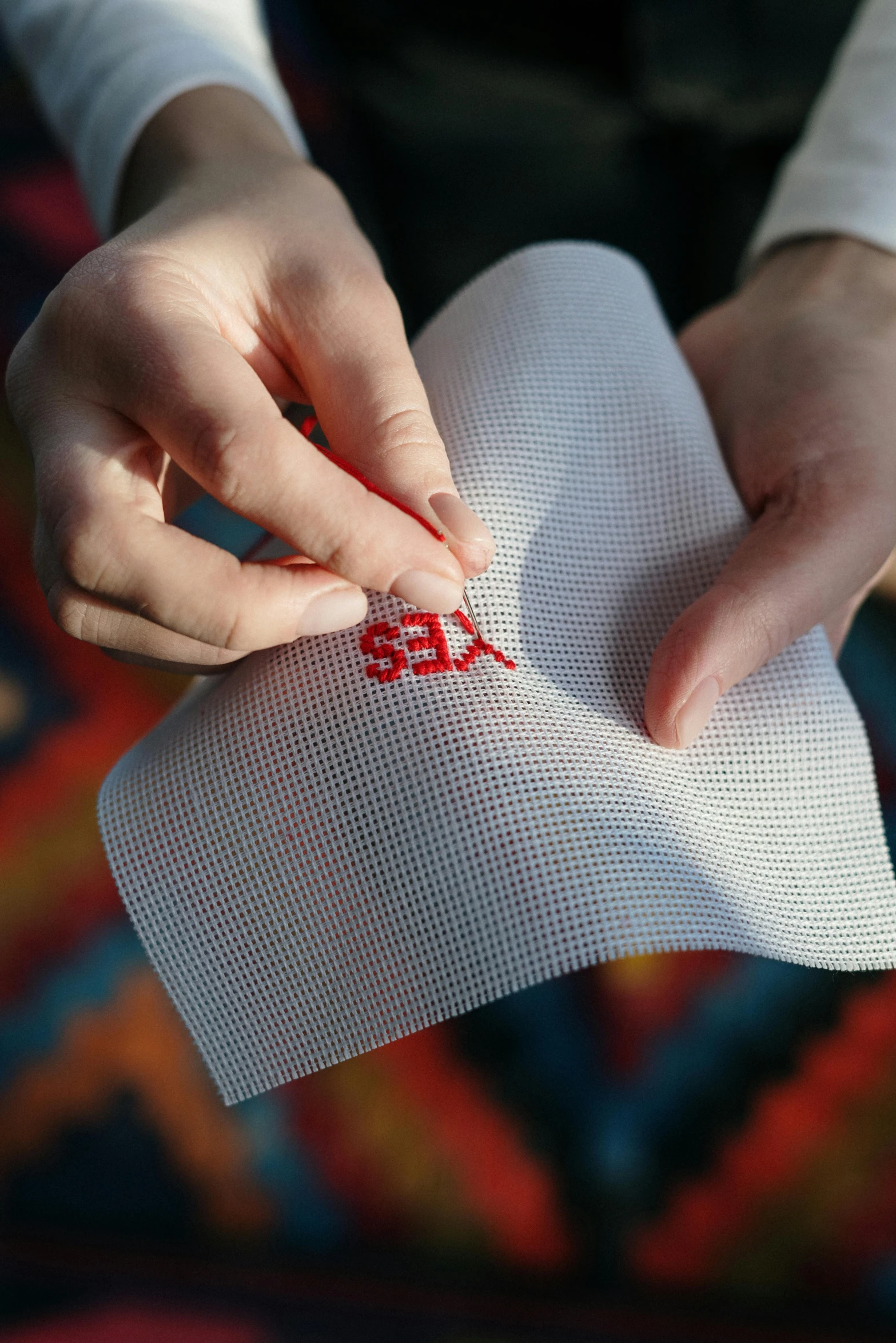 a close up of a person holding a piece of paper, a cross stitch, sket - one x iamretro, making out, red fabric, medium - shot