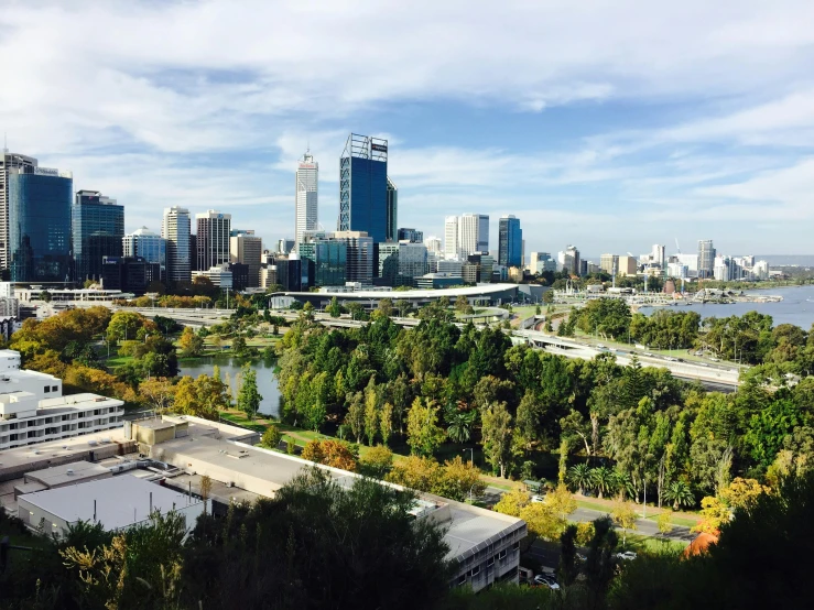 a view of a city from the top of a hill, by Liza Donnelly, pexels contest winner, hurufiyya, royal garden landscape, “ iron bark, clear and sunny, captured on iphone