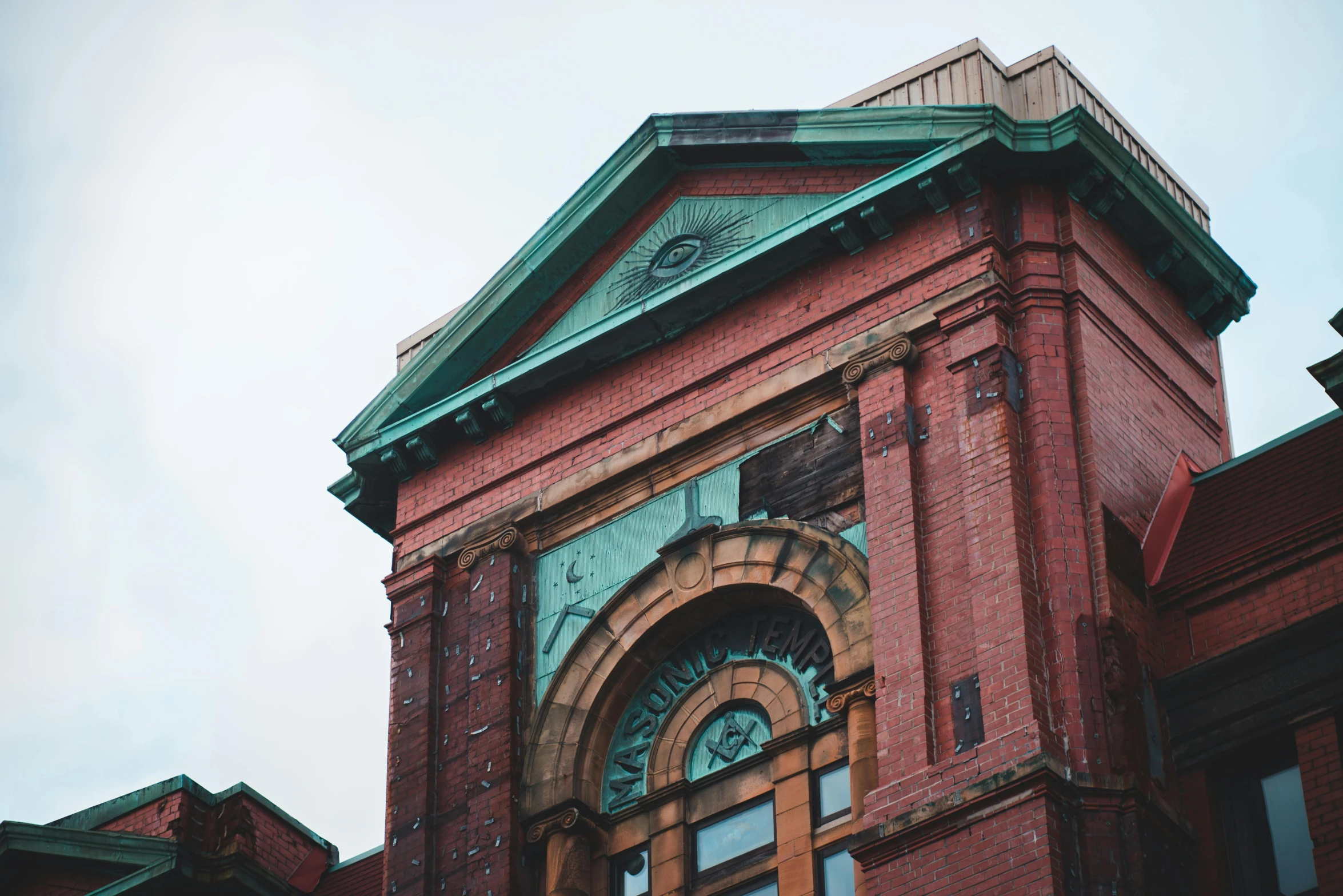 a clock that is on the side of a building, inspired by Sydney Prior Hall, unsplash, vancouver school, copper patina, 1990's photo, gothic building style, over-shoulder shot