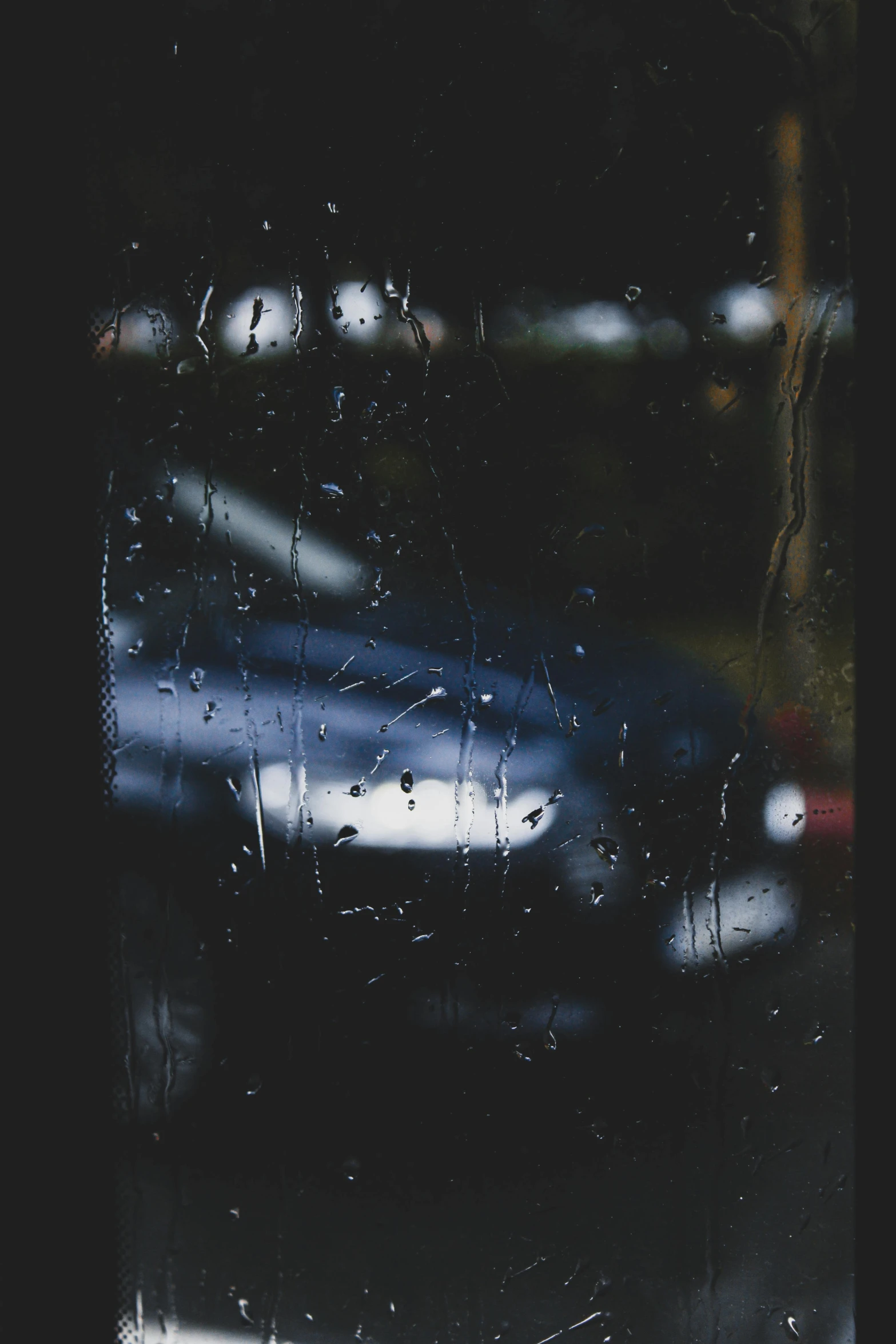 a close up of a window with a car in the background, inspired by Elsa Bleda, unsplash contest winner, carnal ) wet, transparent black windshield, depressed mood, (night)