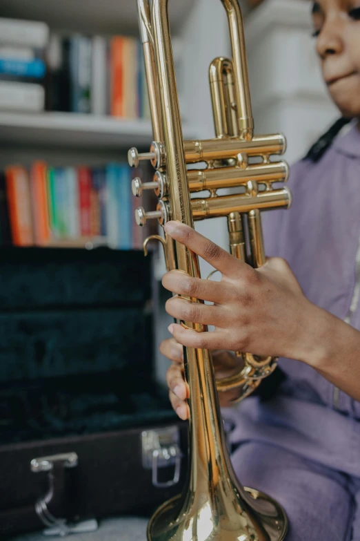 a close up of a person holding a trumpet, multiple stories, at home, schools, sleek spines