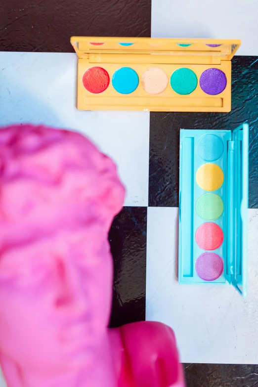 a pink ice cream cone sitting on top of a checkered floor, a pop art painting, inspired by Damien Hirst, trending on pexels, perfect colorful eyeshadows, plasticine models, board games on a table, product display photograph