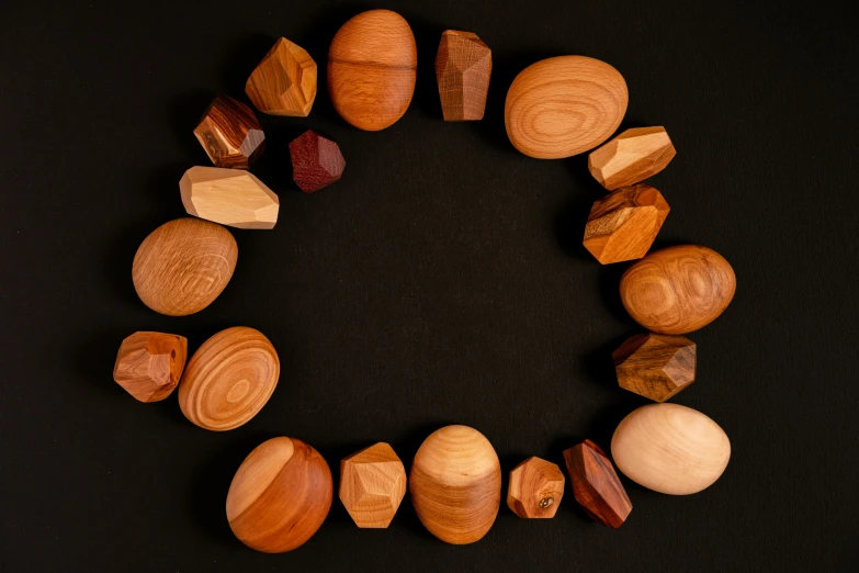 wooden beads arranged in a circle on a black background, inspired by Jan Rustem, unsplash, land art, faceted, cedar, various items, magnificent oval face