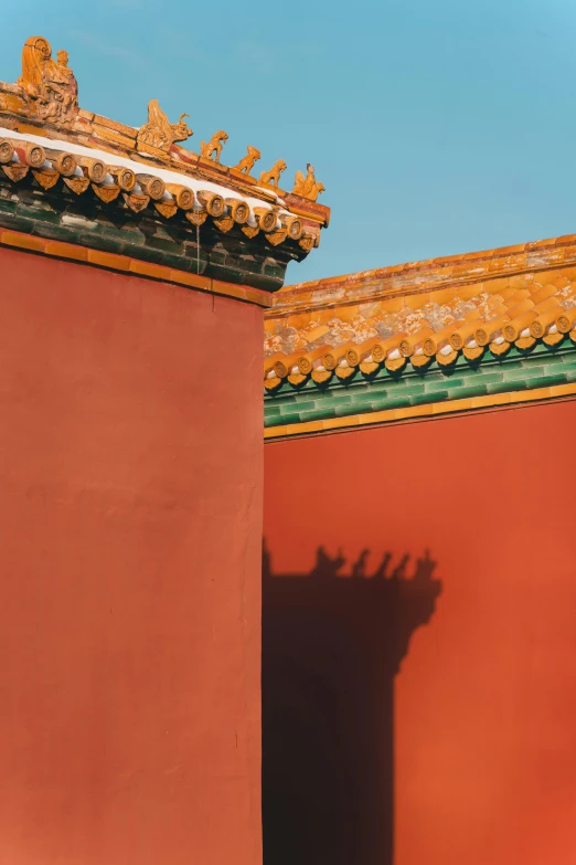 a red building with a blue sky in the background, inspired by Zhang Zeduan, trending on unsplash, walls with tone of yellow, shadow play, forbidden city, square