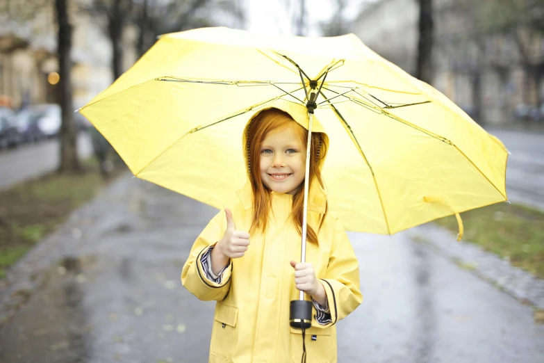 a little girl in a yellow raincoat holding an umbrella, pexels, redhead girl, thumbnail, thumb up, max dennison