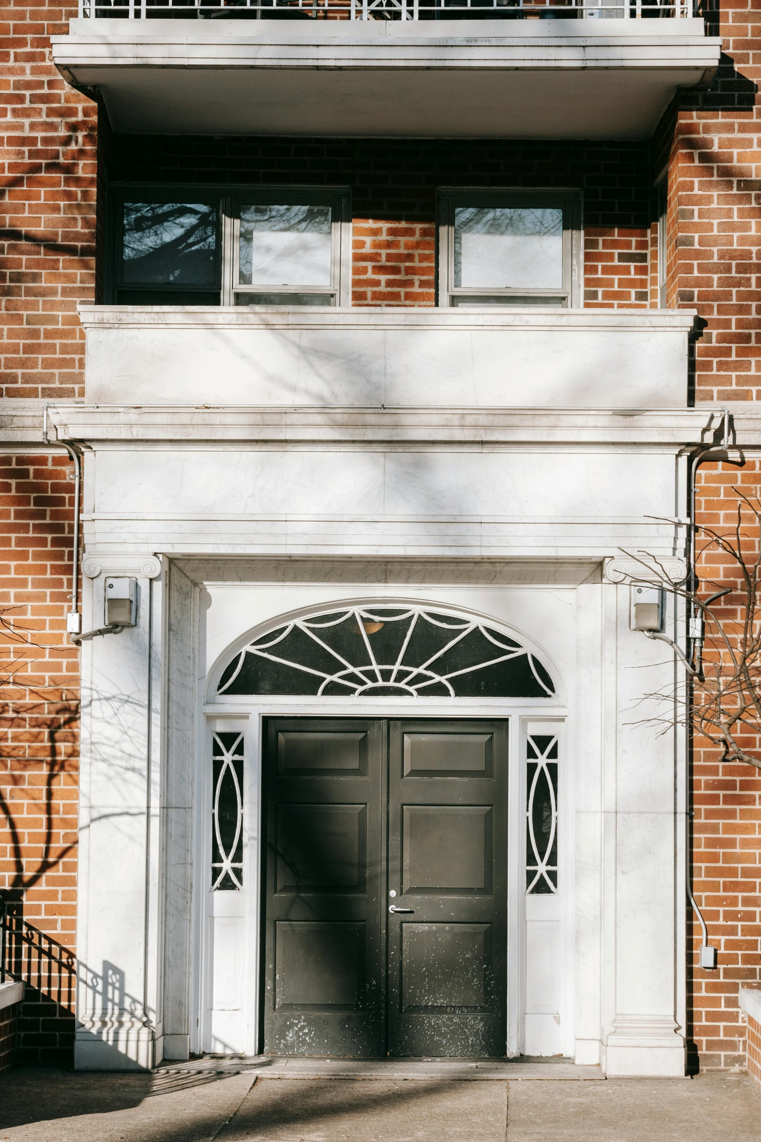 a red fire hydrant sitting in front of a brick building, by Carey Morris, neoclassicism, door to lab, symmetrical doorway, upon a peak in darien, profile image