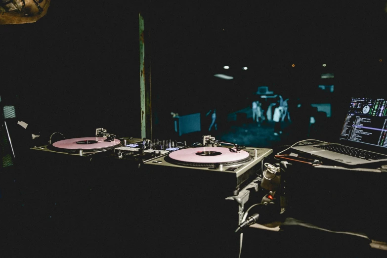 a couple of dj equipment sitting on top of a table, unsplash, private press, during the night, spinning, d. i. y. venue, vinyl material