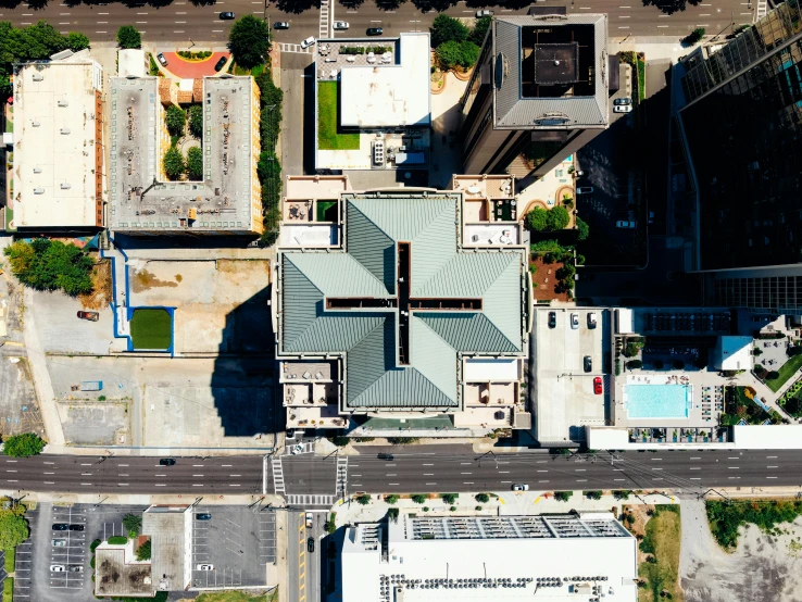 an aerial view of a city with lots of buildings, by Carey Morris, unsplash, photorealism, square, louisiana, impossible stijl architecture, helipad