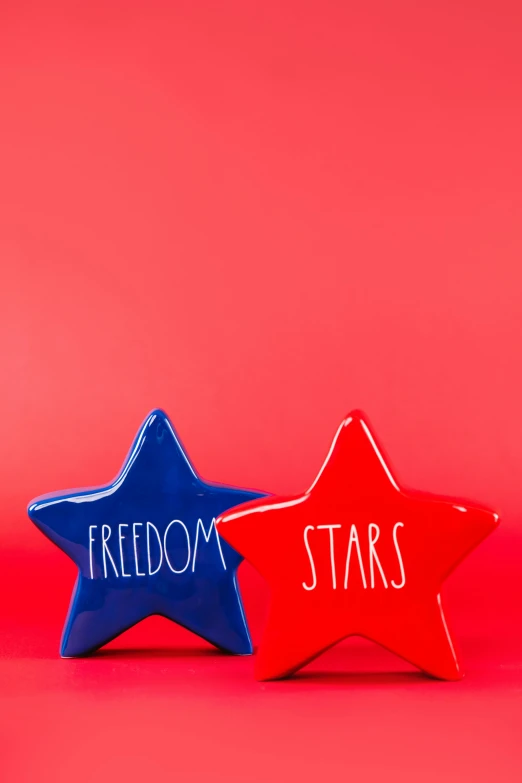 two stars with the words freedom and stars written on them, ceramic, hero shot, blue or red, medium