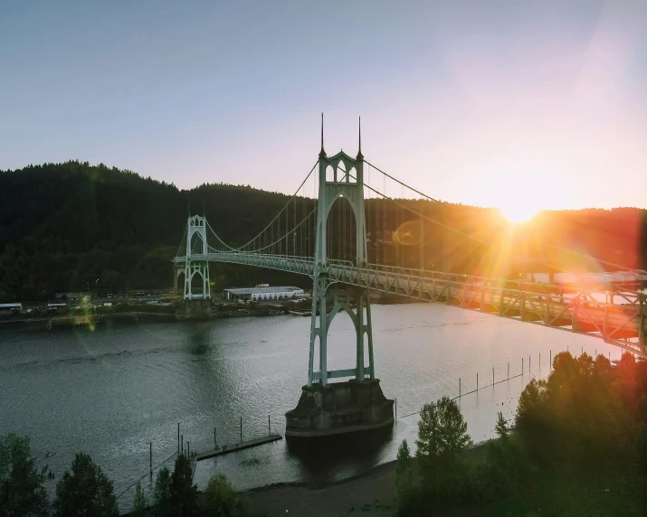 a view of a bridge over a body of water, pexels contest winner, happening, pacific northwest, low sun, drone view of a city, conde nast traveler photo