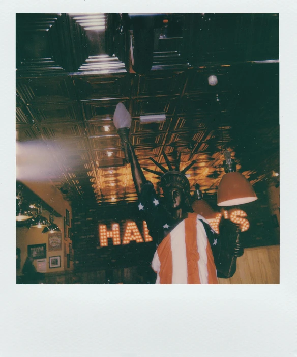 a man standing next to a lamp in a room, a polaroid photo, by Gavin Hamilton, unsplash, happening, stars and stripes, lil uzi vert, hi - res scan, in a bar