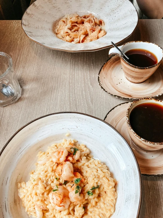 a table topped with plates of food and cups of coffee, rice, shot on iphone 1 3 pro, shrimp, food. craft and adventure