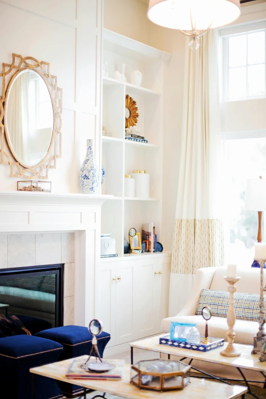 a living room filled with furniture and a fire place, by Nicolette Macnamara, pexels contest winner, white with gold accents, glowing blue interior components, sun lighting, mirror and glass surfaces