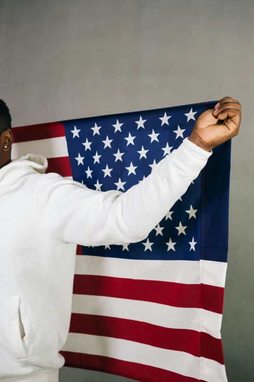 a man holding an american flag in front of his face, an album cover, trending on unsplash, american realism, kevin hart, teddy fresh, praying, programming