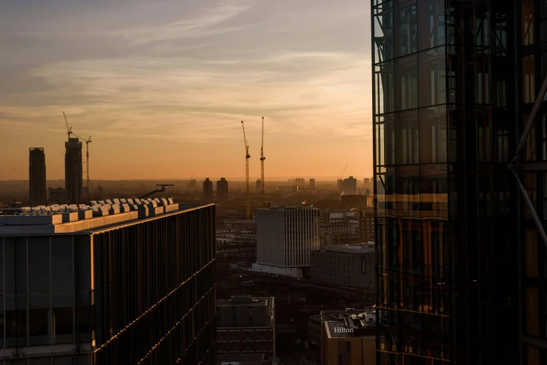 a view of a city from a high rise building, by Sebastian Spreng, pexels contest winner, golden hour 8 k, construction, canary wharf, glass and steel