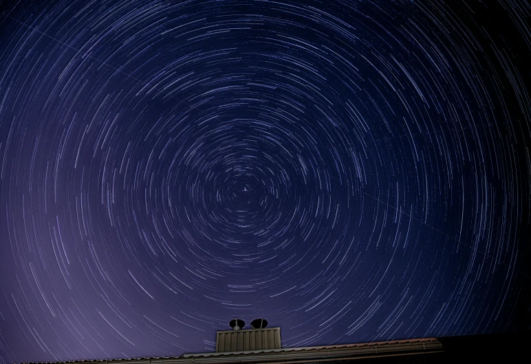 a couple of people sitting on top of a roof under a star filled sky, a microscopic photo, by Gwen Barnard, pexels contest winner, tracingstar trails, hyperdetailed!!, shot on webcam, whirling