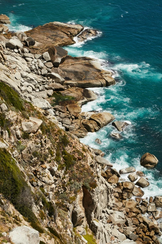 a group of people standing on top of a cliff next to the ocean, south african coast, slide show, texture, explore