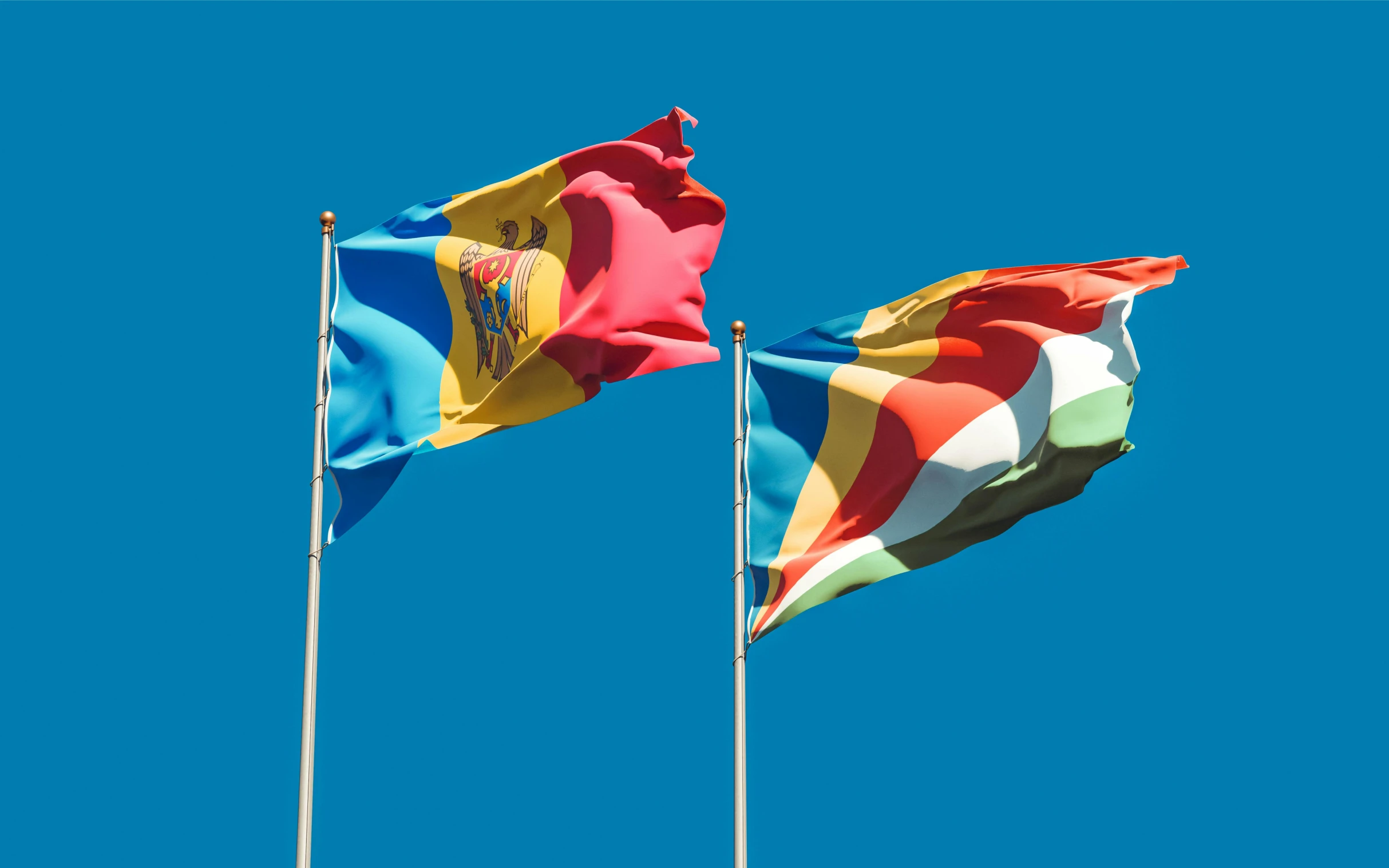 two flags blowing in the wind against a blue sky, by Julia Pishtar, shutterstock, renaissance, multicoloured, square, romanian, avatar image