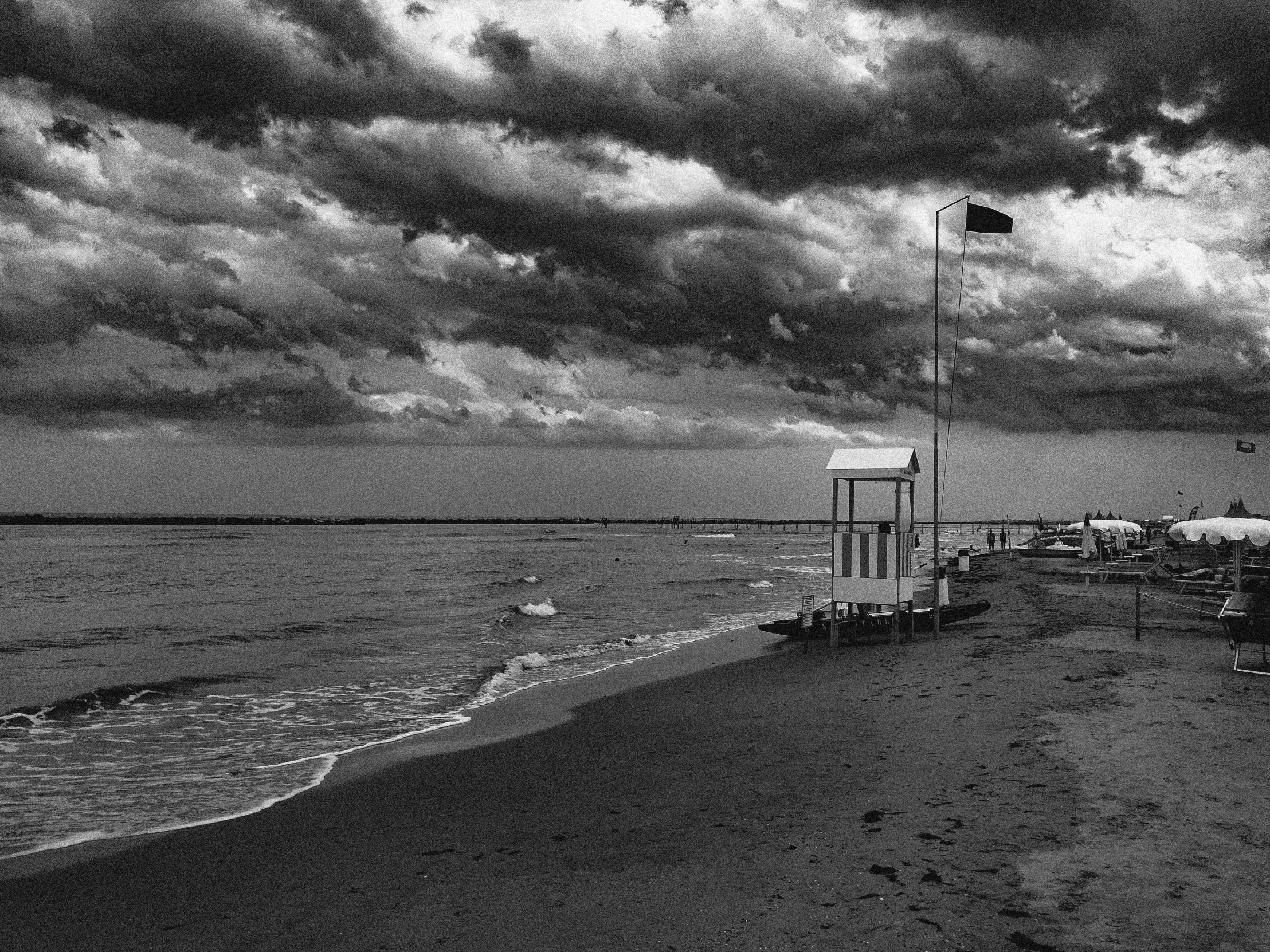 a black and white photo of a beach, by Mathias Kollros, pixabay, fine art, thunder clouds modernism, italian beach scene, monochrome color, new jersey