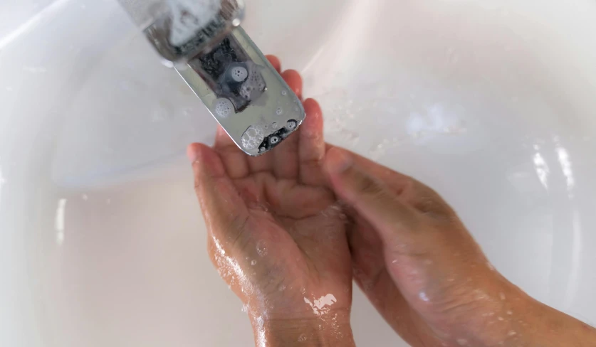 a person washing their hands under a faucet, by Jan Rustem, process art, holding a battery, wet shiny skin, hold up smartphone, rectangle