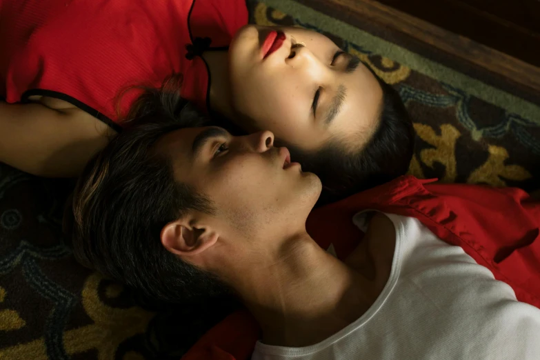 a man and a woman laying next to each other, a portrait, inspired by Fei Danxu, pexels contest winner, full lips, film still from the movie, asian descent, romeo and juliet