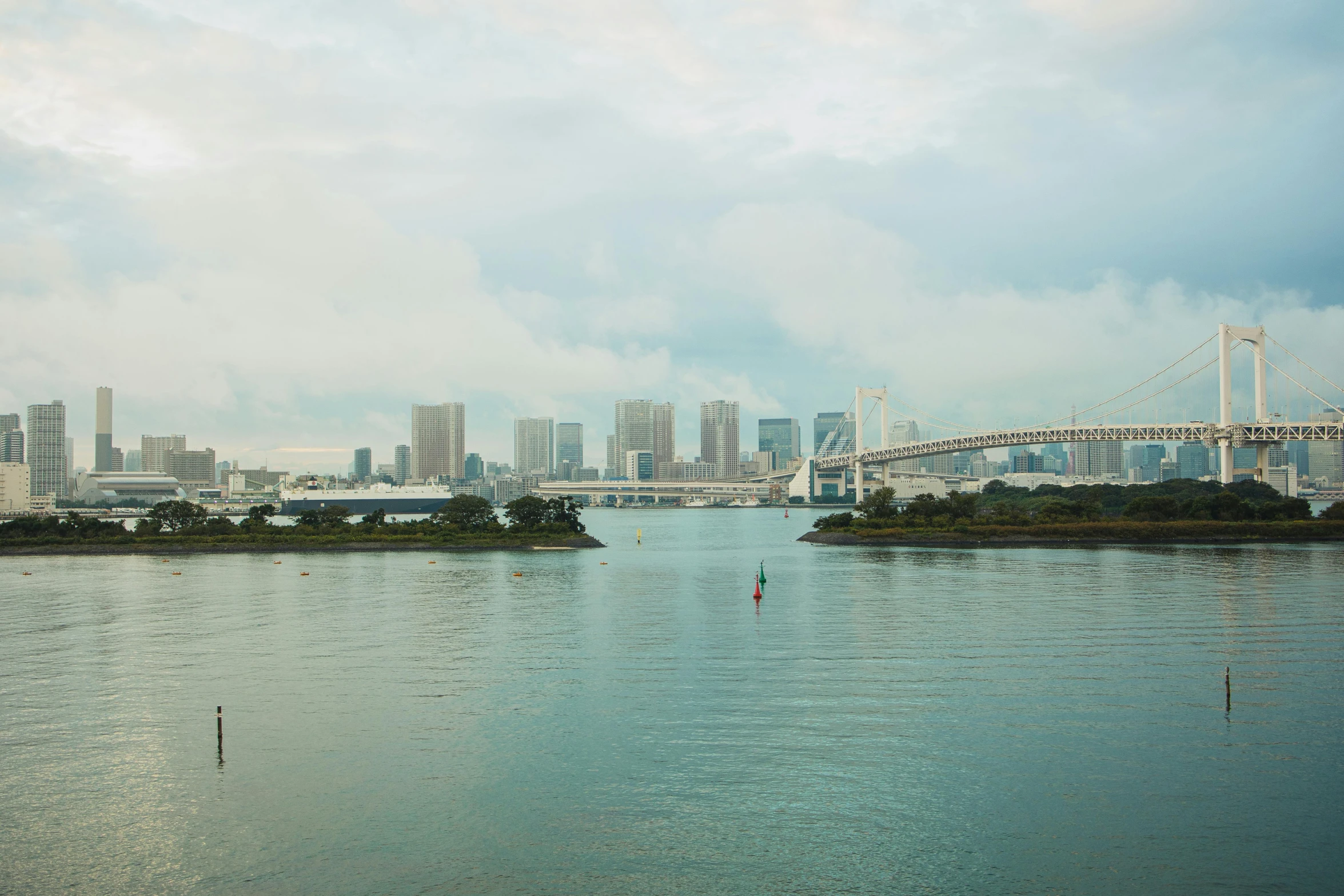 a large body of water with a bridge in the background, by Yasushi Sugiyama, pexels contest winner, sōsaku hanga, neotokyo, medium format, distant photo, julia hetta