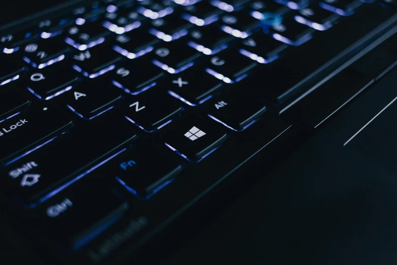a close up of a computer keyboard on a table, a computer rendering, by Carey Morris, unsplash, computer art, windows lit up, microsoft windows logo, dark blue neon light, instagram post