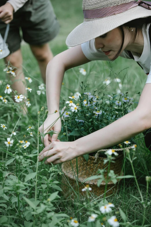 a couple of people that are in the grass, by Mei Qing, pexels contest winner, visual art, picking flowers, chamomile, wearing farm clothes, filled with plants