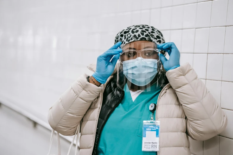a woman wearing a face mask and gloves, a picture, trending on pexels, nurse costume, lizzo, glass visor, thumbnail