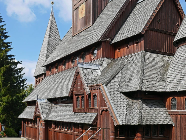 a large wooden building with a clock tower, by Svend Rasmussen Svendsen, pexels contest winner, cloisonnism, wearing norse armor, gray, tiled roofs, museum photo