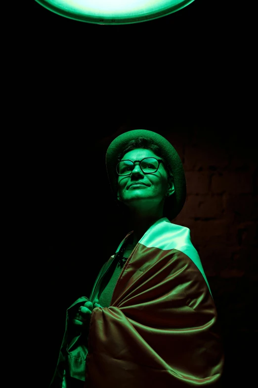 a man standing under a green light in a dark room, a portrait, by Alejandro Obregón, pauline hanson as a clown, woman with hat, non-binary, 15081959 21121991 01012000 4k